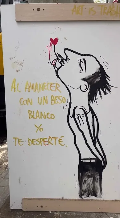 Plade med malet figur og poetisk linje om daggry i Barcelona – Art Is Trash