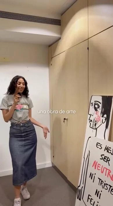 Femme montrant un tableau d'Art Is Trash dans un appartement, Barcelone, Art Is Trash