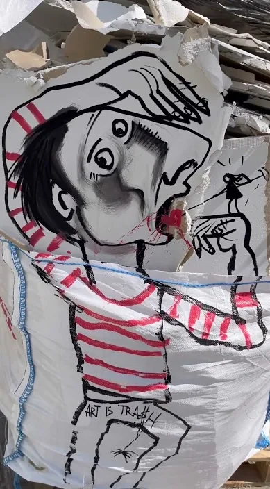 En stor tegning af en figur i stribet trøje på gaden i Barcelona – Art Is Trash