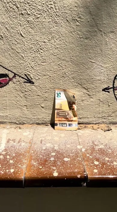 Small cardboard box with a drawing, left on a street ledge, Barcelona, Art Is Trash